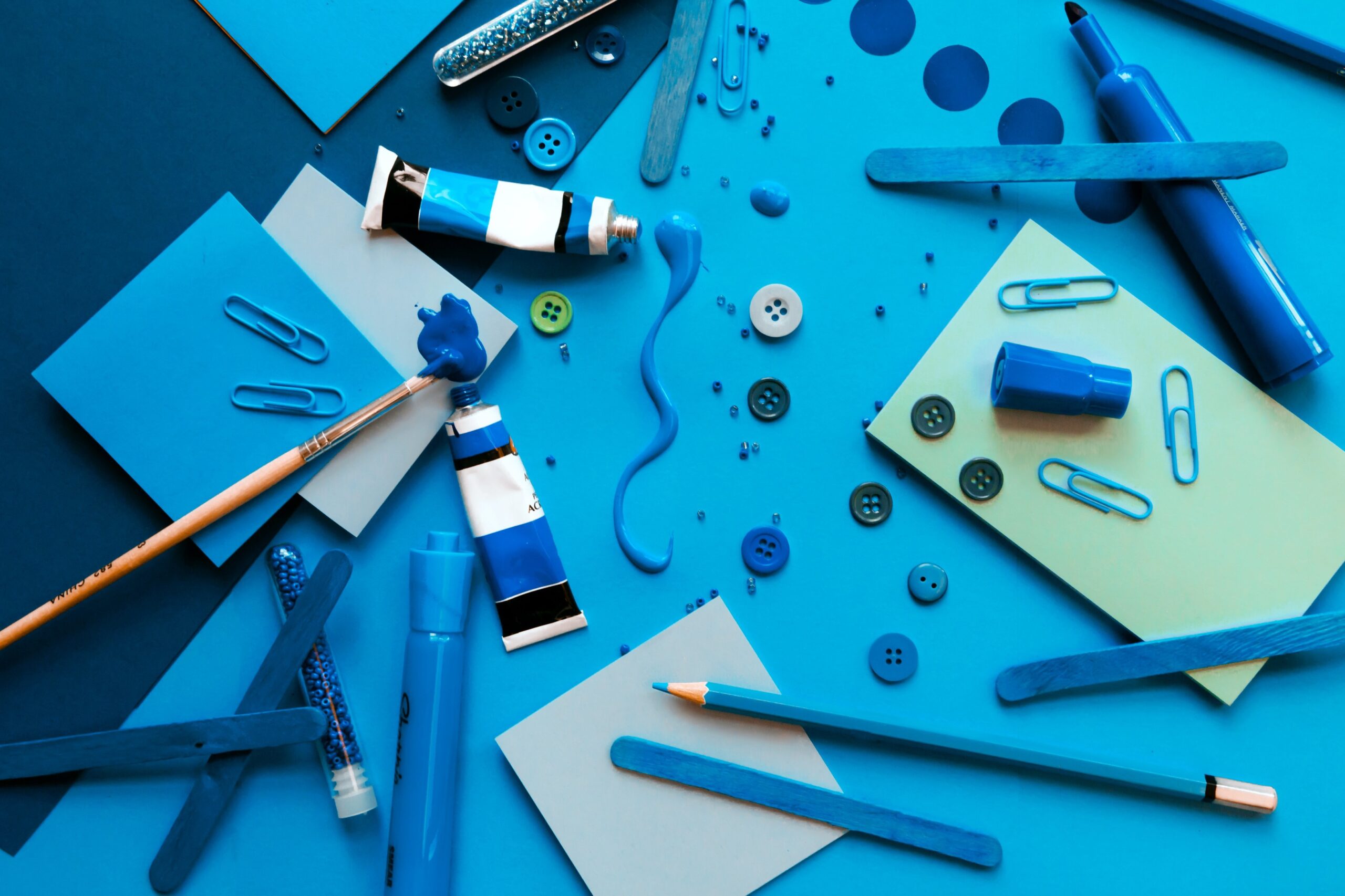 color tubes and all things are scattered on blue table